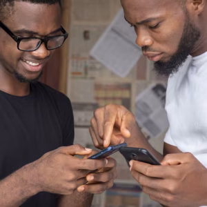shallow-focus-two-young-african-males-sharing-content-through-their-phones_181624-44999-1.avif
